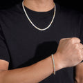 Model wears yellow gold 4mm moissanite tennis bracelet on wrist with matching VVS tennis chain – CustomHipHop
