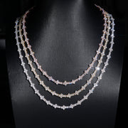 Three moissanite tennis chains in white, yellow and rose 10K gold layered on a dark display bust – CustomHipHop