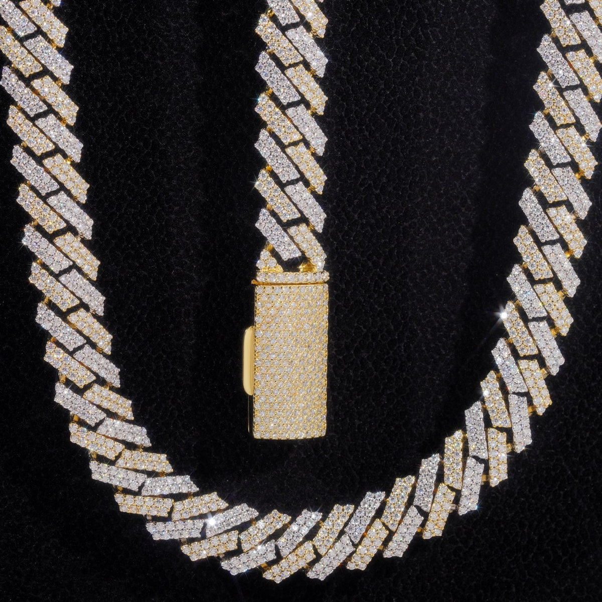 Close-up of a two-tone iced-out moissanite Cuban link chain, rows of small stones set edge to edge beside a pavé box clasp — CustomHipHop